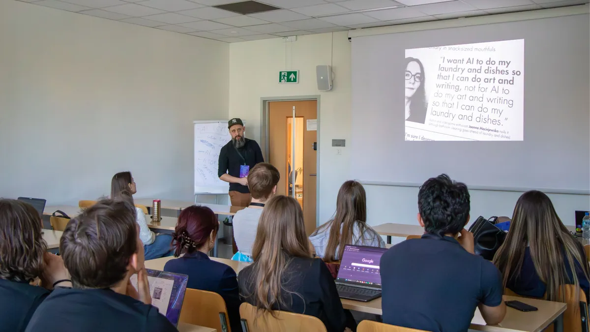 Marek Malinowski delivering an AI for Project Management lecture with flipchart notes and slide deck