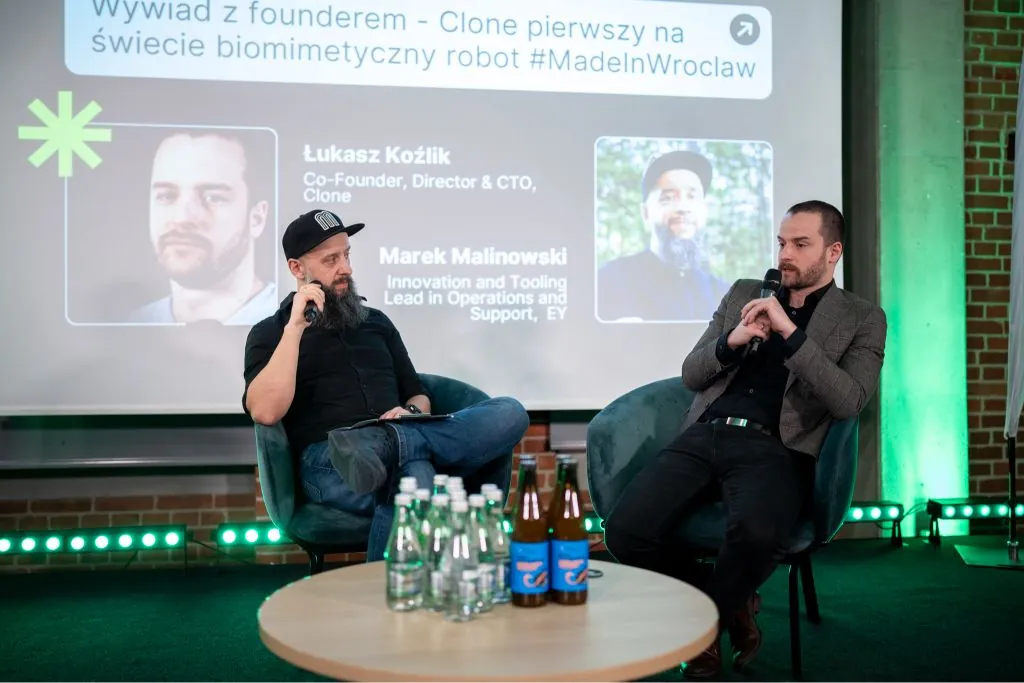 Marek Malinowski moderating a founder interview on stage at Made in Wroclaw Venture Connect